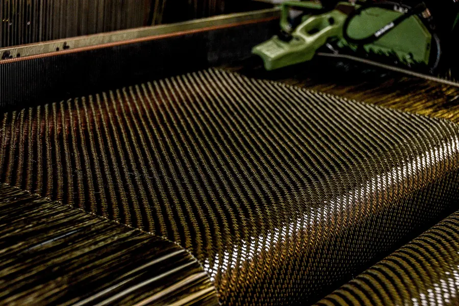 Woven carbon fibre fabric on a loom