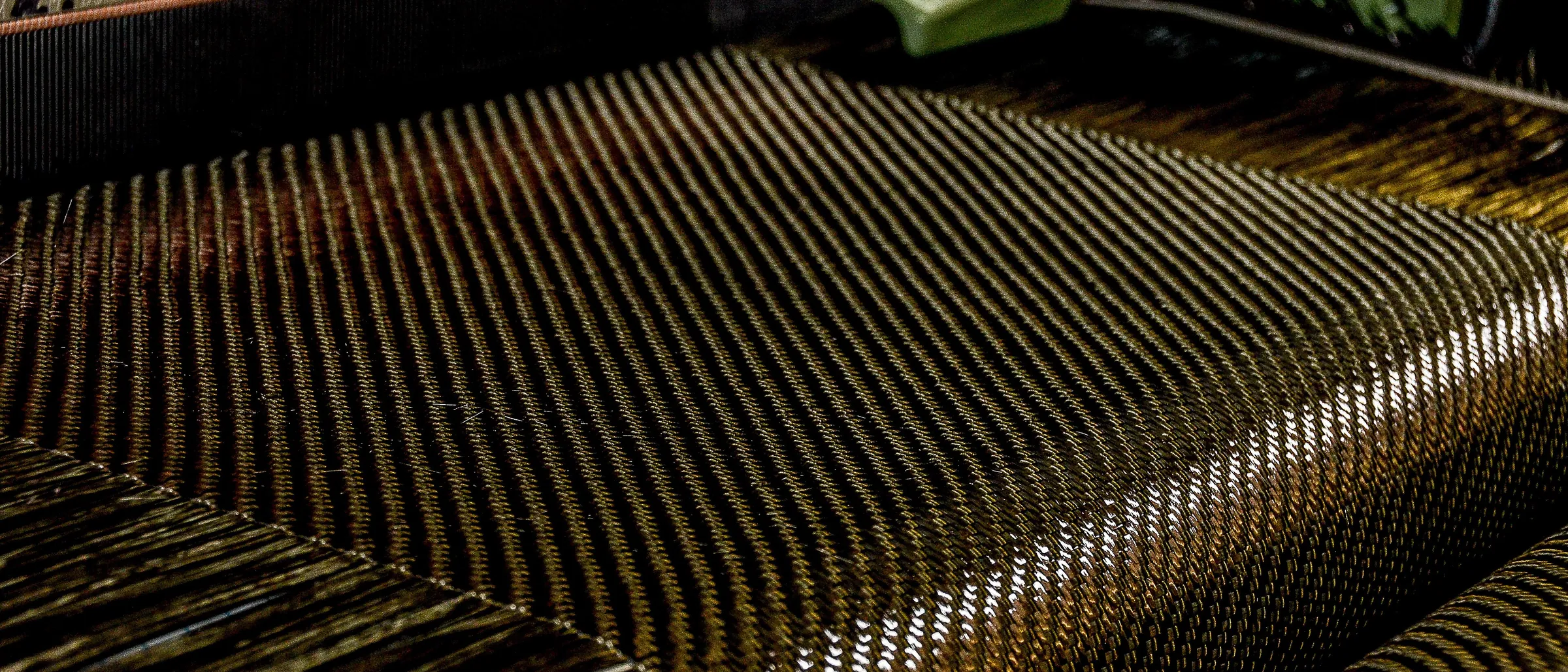 Woven carbon fibre fabric on a loom