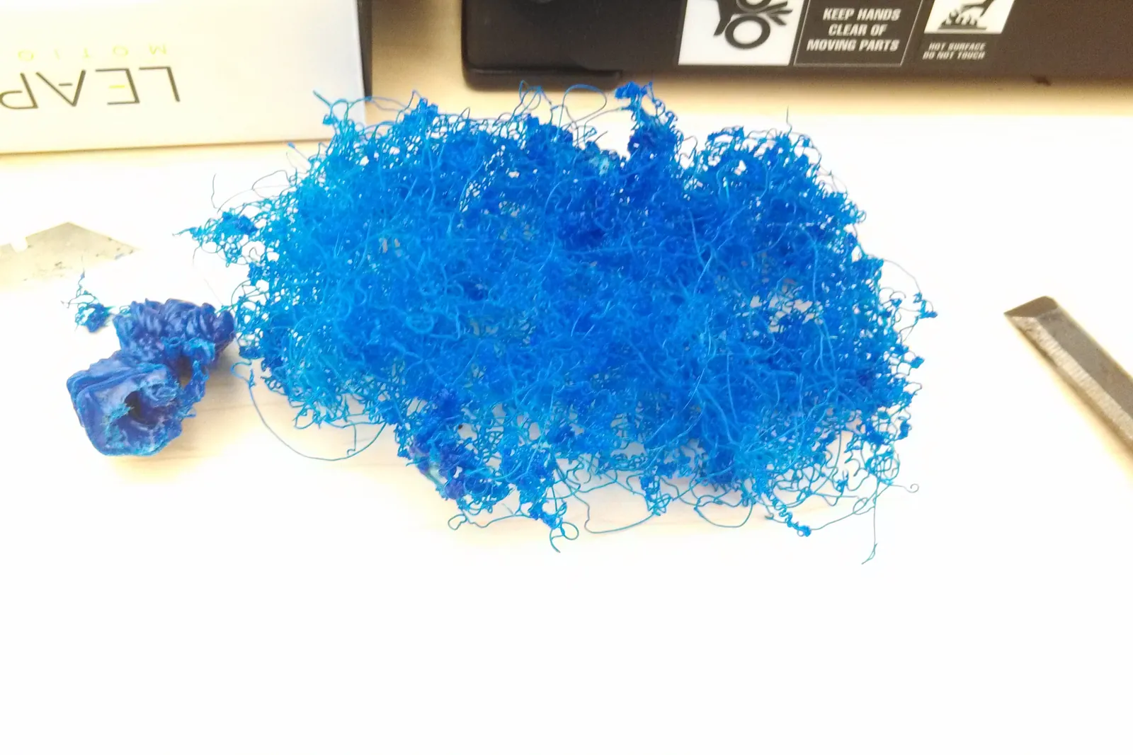 A tangle of stray extruded filament left on a printer bed by a failed print