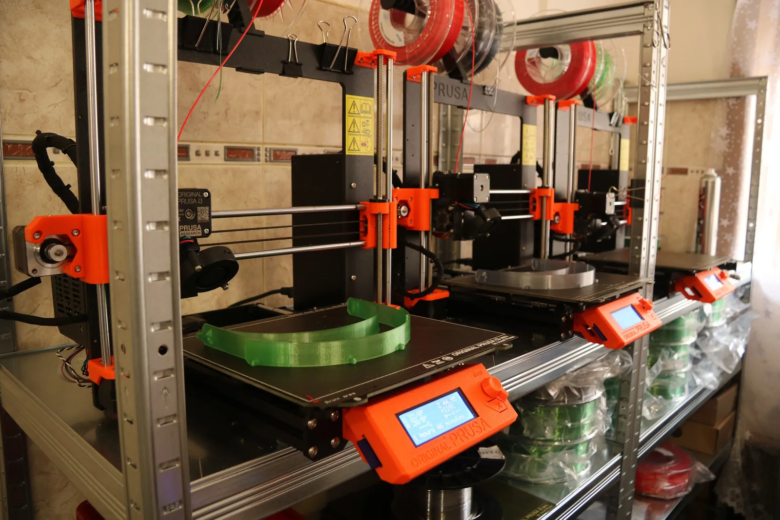 A rack of open-frame printers running the same part