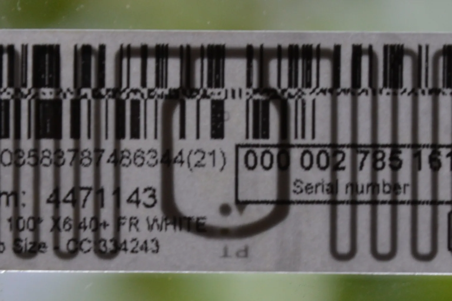 A shipping label with an RFID antenna visible behind the barcode